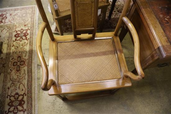 A pair of Chinese Ming style hardwood elbow chairs, with caned seats, W.54cm, D.48cm, H.95cm